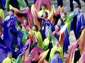 Multi-colored capes-wearing Japanese delegates march into stadiu